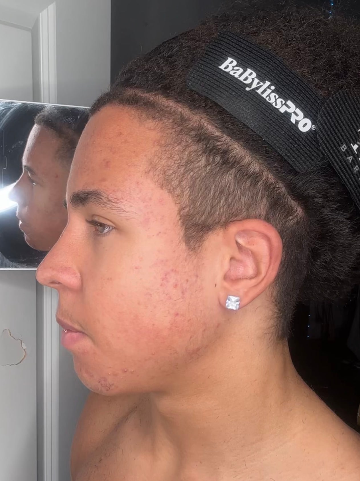 A finished self-cut — taper and lineup, done in a bathroom mirror